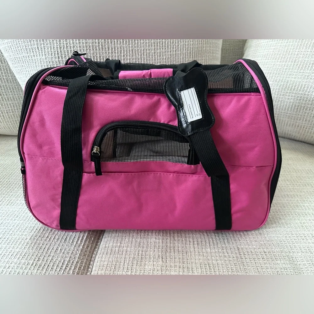 Pink small dog carrying cage.